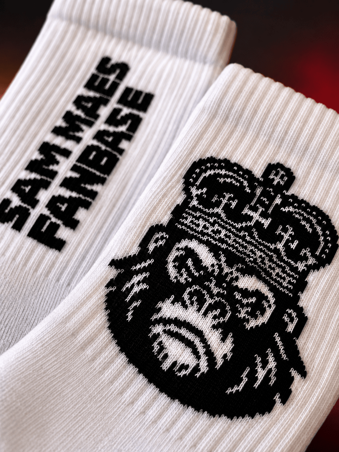 Sam Maes Fanbase Socks, close-up of the knitted crown motif and Sam Maes Fanbase lettering