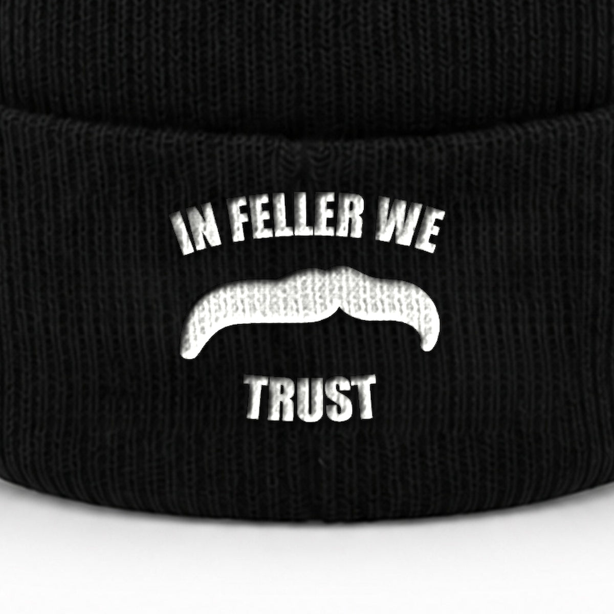 Manuel Feller In Feller We Trust Beanie in black with white "In Feller we trust" moustache motif – close-up of the embroidery