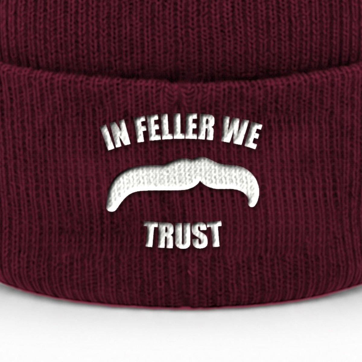 Manuel Feller In Feller We Trust Beanie in burgundy with white "In Feller we trust" moustache motif – close-up of the embroidery